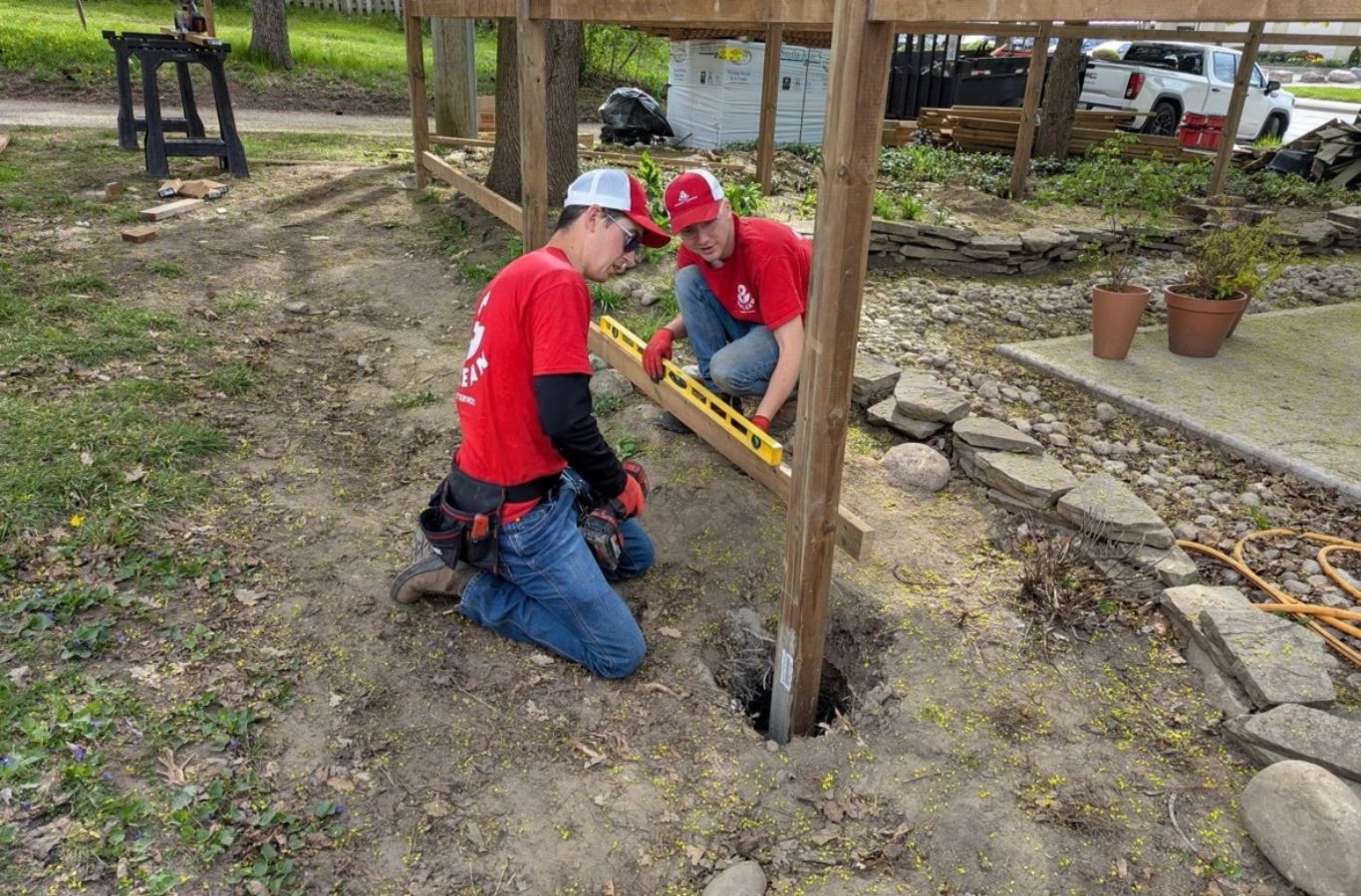 Fence professional checking post spacing and gate alignment with measuring tools