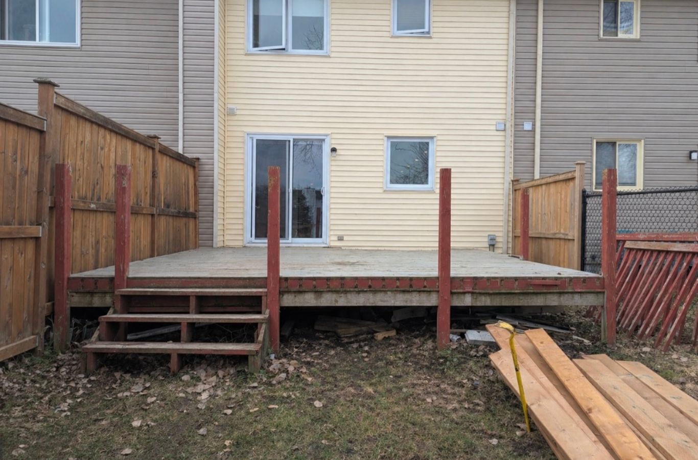 Backyard fence installation beside deck and lawn at Kitchener family property