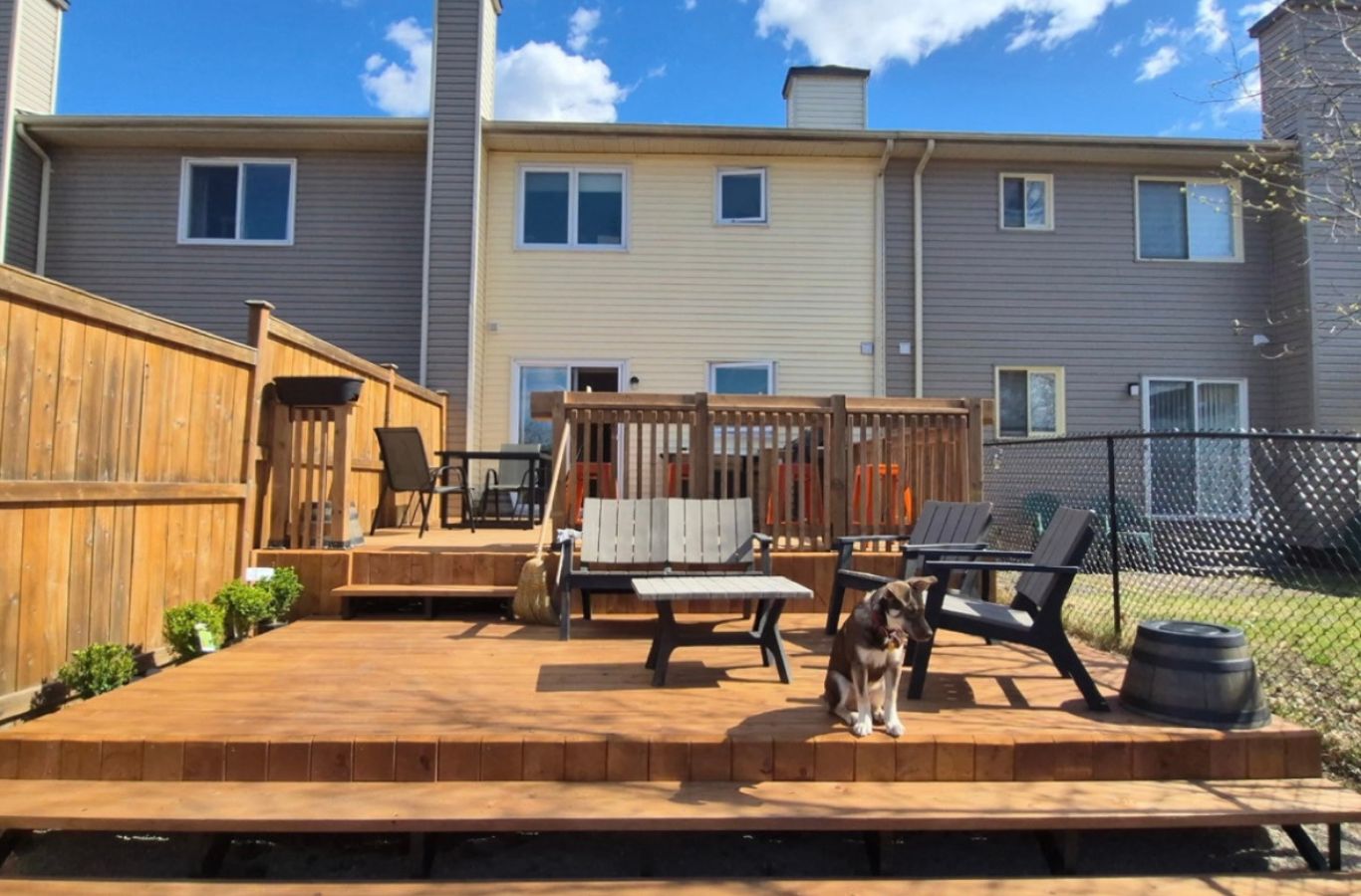 Deck Builder in Waterloo - ON marking deck footings in a fenced residential backyard